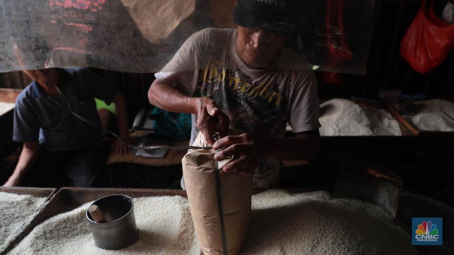 Pekerja mengangkat karungan beras di Pasar Tradisional Kebayoran Lama, Rabu, (22/2). (CNBC Indonesia/ Muhammad Sabki)