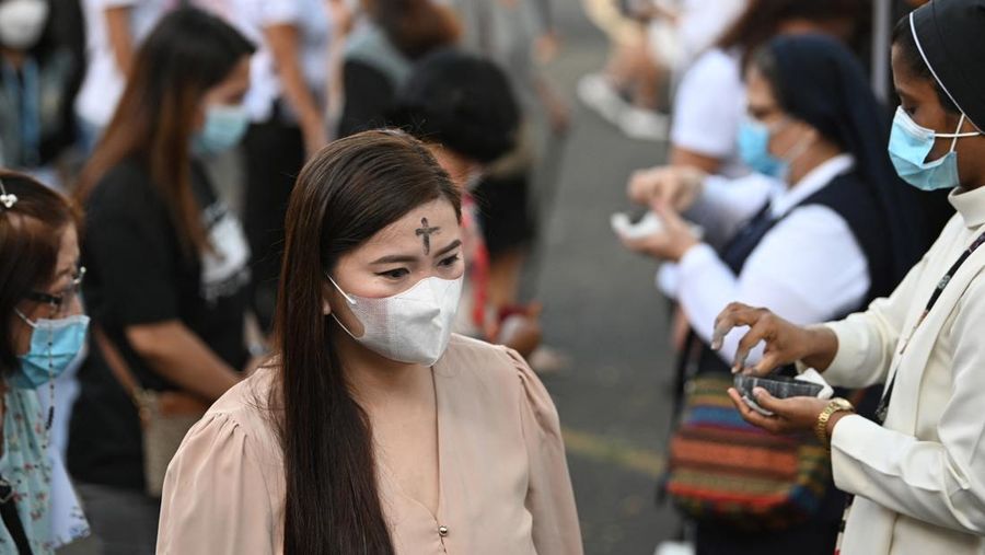 Seorang umat Katolik berjalan setelah menerima abu pada peringatan Rabu Abu di sebuah gereja di Paranaque City pinggiran kota Manila pada 22 Februari 2023. (TED ALJIBE/AFP via Getty Images)