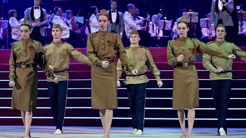 Orang-orang berkumpul di dekat monumen pendiri Uni Soviet Vladimir Lenin saat mereka tiba untuk konser patriotik yang didedikasikan untuk Hari Pembela Tanah Air yang akan datang di stadion Luzhniki di Moskow pada 22 Februari 2023. (AFP via Getty Images/NATALIA KOLESNIKOVA)