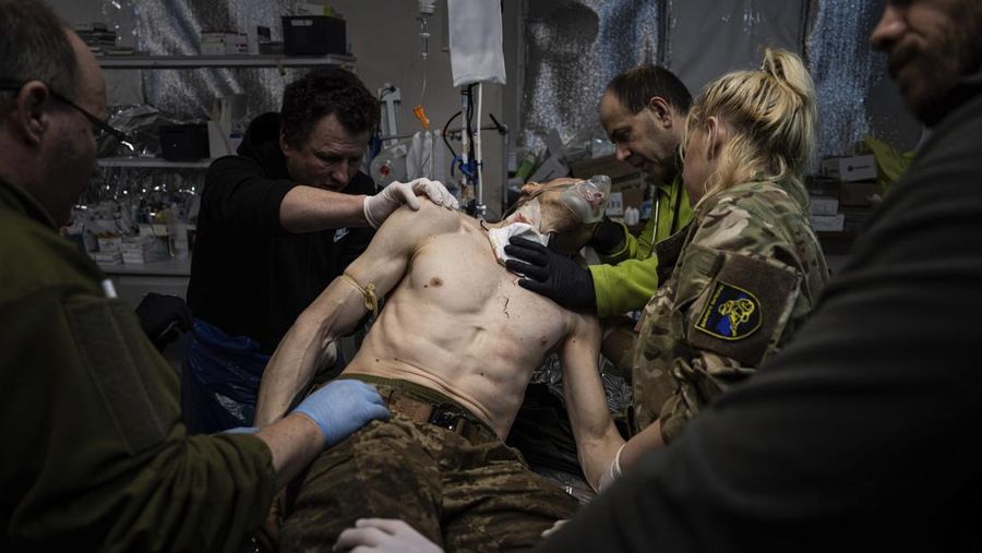 Ukrainian military medics treat their wounded comrade at the field hospital near Bakhmut, Ukraine, Sunday, Feb. 26, 2023. (AP Photo/Evgeniy Maloletka)