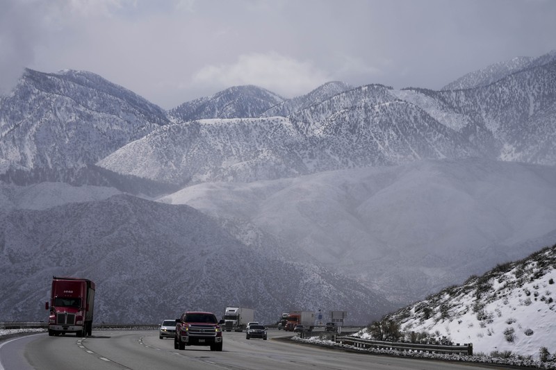 APTOPIX Winter Weather California Two palms trees are backdropped by snow-covered mountains in Hesperia, Calif., Wednesday, March 1, 2023. (AP Photo/Jae C. Hong)