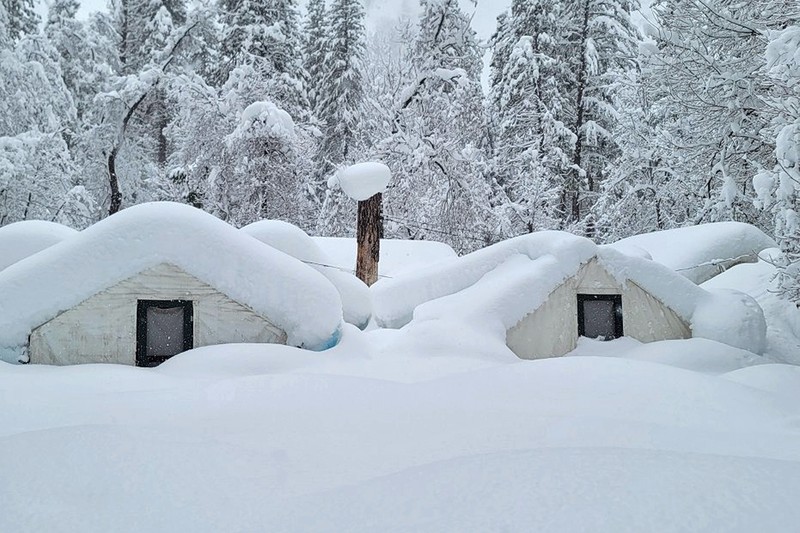 APTOPIX Winter Weather California Two palms trees are backdropped by snow-covered mountains in Hesperia, Calif., Wednesday, March 1, 2023. (AP Photo/Jae C. Hong)