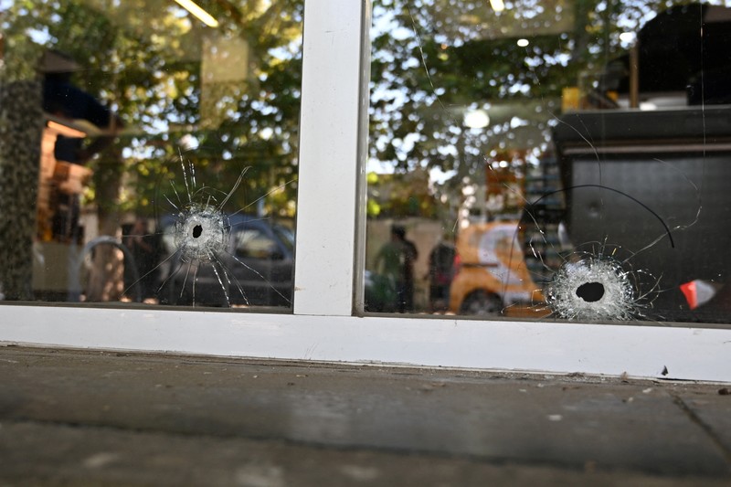 ARGENTINA-VIOLENCE/MESSI A police officer stands guard outside a supermarket that belongs to the family of Antonela Roccuzzo, wife of Argentine soccer star Lionel Messi, after after two people on motorcycles attacked it and left a threatening message for Messi and the city mayor, Pablo Javkin, according to local media, in Rosario, Argentina March 2, 2023. REUTERS/Luciano Bisbal NO RESALES. NO ARCHIVES