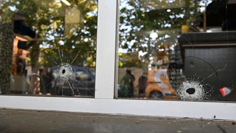 A police officer stands guard outside a supermarket that belongs to the family of Antonela Roccuzzo, wife of Argentine soccer star Lionel Messi, after after two people on motorcycles attacked it and left a threatening message for Messi and the city mayor, Pablo Javkin, according to local media, in Rosario, Argentina March 2, 2023. REUTERS/Luciano Bisbal NO RESALES. NO ARCHIVES