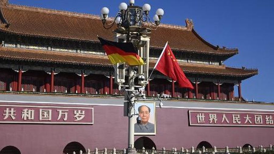 A German and Chinese flags hang from a road lamp in front of Tiananmen gate in Beijing on November 4, 2022 as German Chancellor Olaf Scholz arrives for a visit to China. (Photo by AFP)