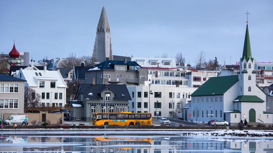 REYKJAVIK, SOUTH  ICELAND: Yellow bus - coach - in the capital city of Reykjavik and Lutheran church Hallgrímskirkja Cathedral, Iceland.  (Photo by Tim Graham/Getty Images)