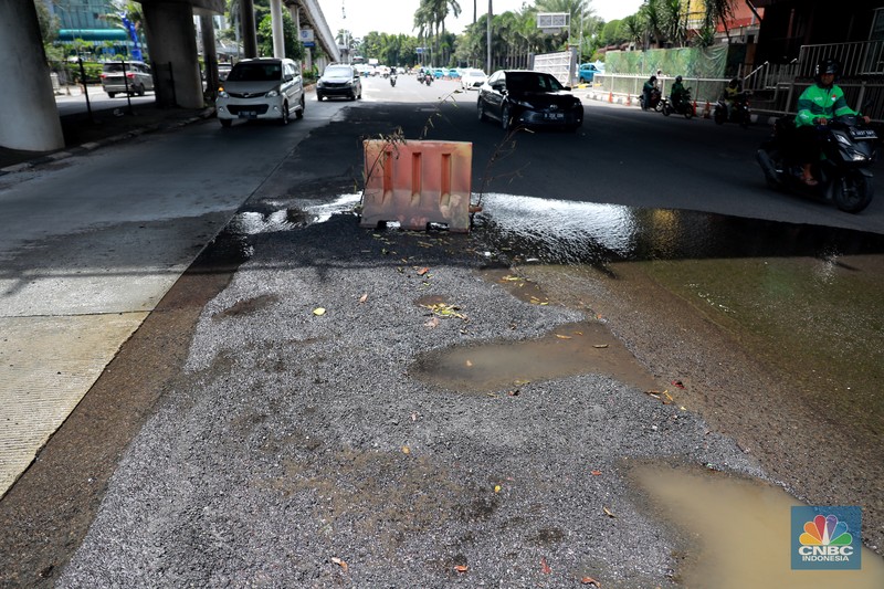 Sejumlah kendaraan melintas di kawasan jalan berlubang di Jalan Metro Pondok Indah, Jakarta, Senin, 6/3. Ruas jalan tersbut terlihat terdapat jalan yang berlubang dan basah sehingga dapat membahayakan pengguna jalan. (CNBC Indonesia/ Muhammad Sabki)