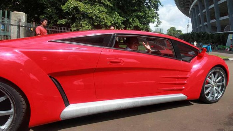 Dahlan Iskan menjajal mobil Tucuxi warna merah di kompleks Gelora Bung Karno (GBK), Jakarta, Minggu (13/12/2012). (detikcom/Ari Saputra)