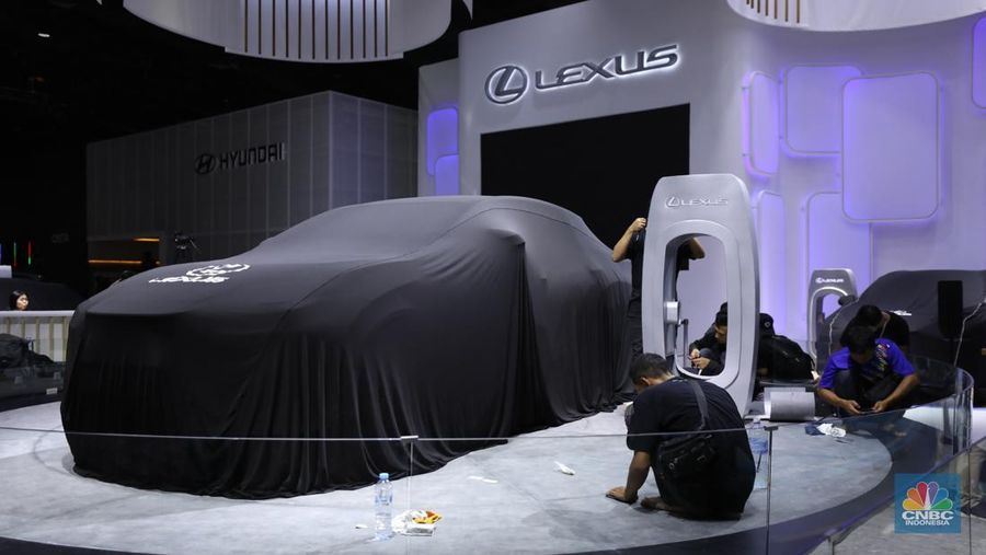 Pekerja menyelesaikan dekorasi booth pameran Gabungan Industri Kendaraan Bermotor Indonesia (Gaikindo) Auto Week Jakarta di Jakarta Convention Center (JCC), Kamis (9/3/2023). (CNBC Indonesia/Tri Susilo)