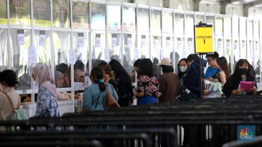 Pengunjung berfoto di depan banner penukaran tiket Blackpink, di Senayan, Jakarta, Jumat, 10/3. Seperti diketahui konser BLACKPINK akan digelar besok selama dua hari di Stadion Utama Gelora Bung Karno, yakni pada 11 dan 12 Maret 2023 mendatang. (CNBC Indonesia/ Muhammad Sabki)