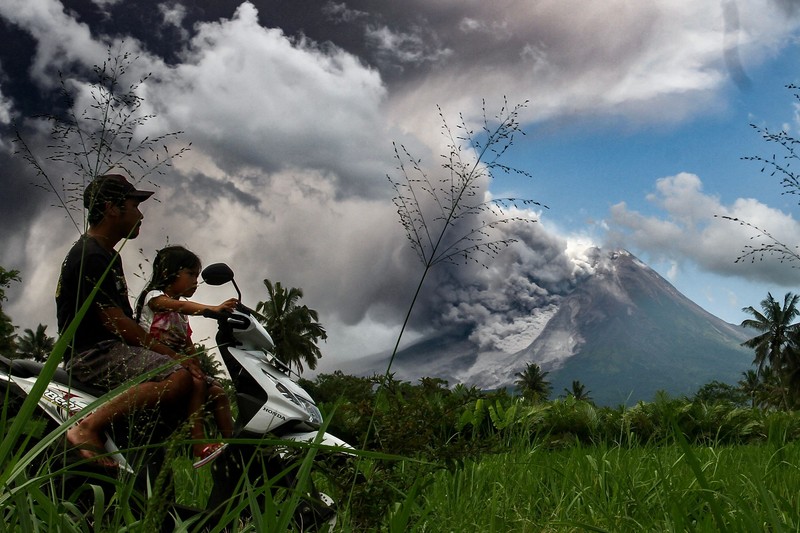 TOPSHOT - Thick smoke rises during an eruption from Mount Merapi, Indonesias most active volcano, as seen from Tunggularum village in Sleman on March 11, 2023. (Photo by DEVI RAHMAN / AFP) (Photo by DEVI RAHMAN/AFP via Getty Images)
