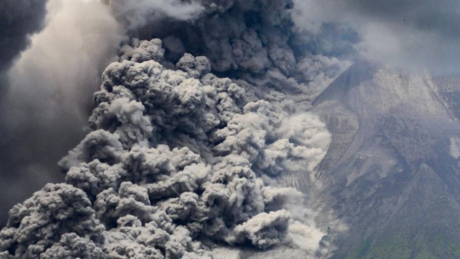 TOPSHOT - Thick smoke rises during an eruption from Mount Merapi, Indonesias most active volcano, as seen from Tunggularum village in Sleman on March 11, 2023. (Photo by DEVI RAHMAN / AFP) (Photo by DEVI RAHMAN/AFP via Getty Images)