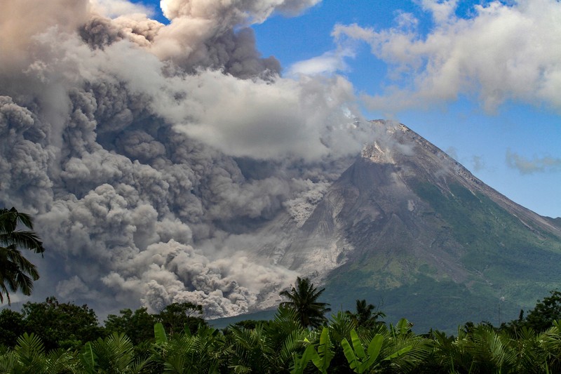 1248014746 TOPSHOT - Thick smoke rises during an eruption from Mount Merapi, Indonesias most active volcano, as seen from Tunggularum village in Sleman on March 11, 2023. (Photo by DEVI RAHMAN / AFP) (Photo by DEVI RAHMAN/AFP via Getty Images)