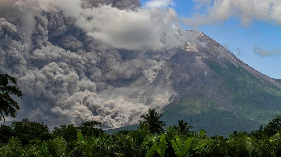 TOPSHOT - Thick smoke rises during an eruption from Mount Merapi, Indonesias most active volcano, as seen from Tunggularum village in Sleman on March 11, 2023. (Photo by DEVI RAHMAN / AFP) (Photo by DEVI RAHMAN/AFP via Getty Images)