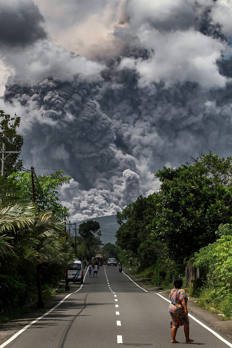 TOPSHOT - Thick smoke rises during an eruption from Mount Merapi, Indonesias most active volcano, as seen from Tunggularum village in Sleman on March 11, 2023. (Photo by DEVI RAHMAN / AFP) (Photo by DEVI RAHMAN/AFP via Getty Images)