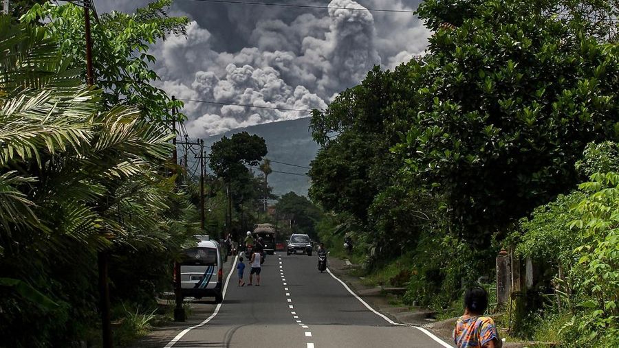 TOPSHOT - Thick smoke rises during an eruption from Mount Merapi, Indonesias most active volcano, as seen from Tunggularum village in Sleman on March 11, 2023. (Photo by DEVI RAHMAN / AFP) (Photo by DEVI RAHMAN/AFP via Getty Images)