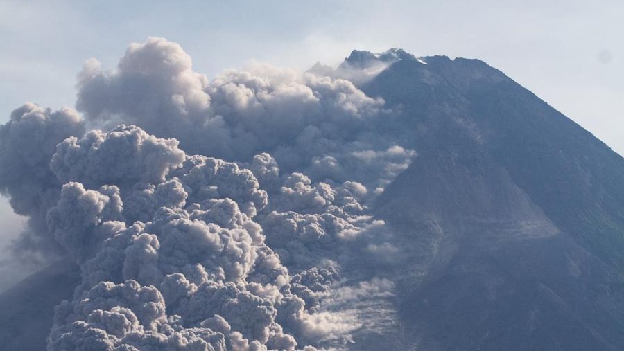 Thick smoke rises during an eruption from Mount Merapi, Indonesia's most active volcano, as seen from the Kaliurang Selatan village in Srumbung, Magelang, Central Java on March 12, 2023. (Photo by DEVI RAHMAN / AFP) (Photo by DEVI RAHMAN/AFP via Getty Images)