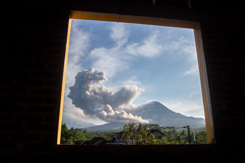 1248048336 Lava spews out of Mount Merapi, Indonesia's most active volcano, as seen from the Kaliurang Selatan village in Srumbung, Magelang, Central Java on March 12, 2023. (Photo by DEVI RAHMAN / AFP) (Photo by DEVI RAHMAN/AFP via Getty Images)