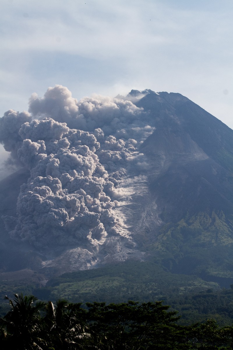 1248048336 Lava spews out of Mount Merapi, Indonesia's most active volcano, as seen from the Kaliurang Selatan village in Srumbung, Magelang, Central Java on March 12, 2023. (Photo by DEVI RAHMAN / AFP) (Photo by DEVI RAHMAN/AFP via Getty Images)