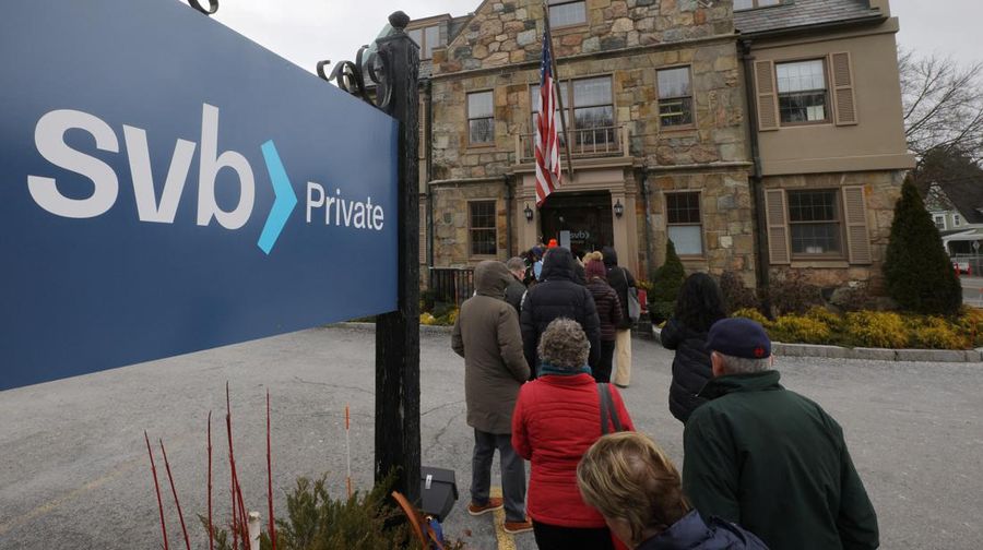 Customers wait in line outside a branch of the Silicon Valley Bank in Wellesley, Massachusetts, U.S., March 13, 2023.     REUTERS/Brian Snyder