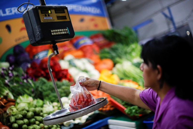 A butcher walks with a shopping cart at a local market, as Argentina's annual inflation rate tore past 100% in February, the country's statistics agency said on Tuesday, the first time it has hit triple figures since a period of hyperinflation in 1991, over three decades ago, in Buenos Aires, Argentina March 14, 2023. REUTERS/Agustin Marcarian     TPX IMAGES OF THE DAY