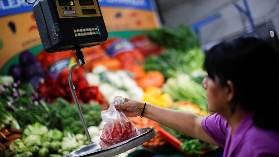 A butcher walks with a shopping cart at a local market, as Argentina's annual inflation rate tore past 100% in February, the country's statistics agency said on Tuesday, the first time it has hit triple figures since a period of hyperinflation in 1991, over three decades ago, in Buenos Aires, Argentina March 14, 2023. REUTERS/Agustin Marcarian     TPX IMAGES OF THE DAY