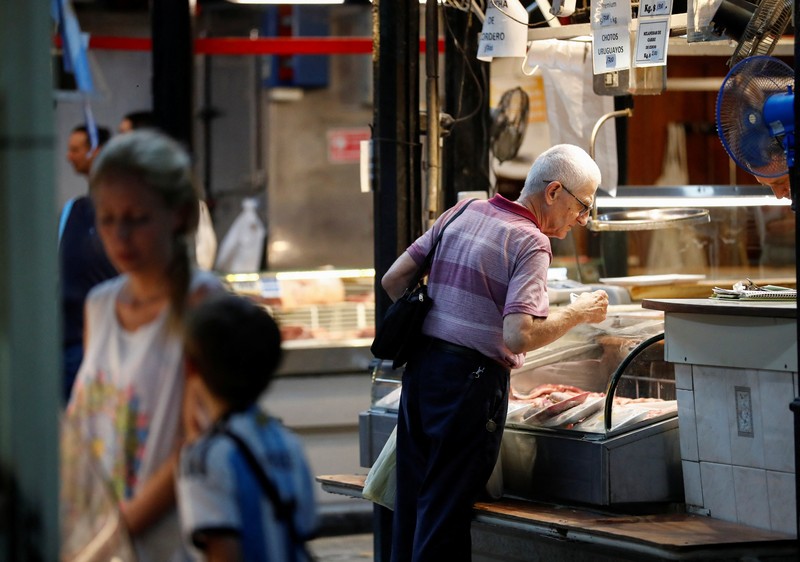 A butcher walks with a shopping cart at a local market, as Argentina's annual inflation rate tore past 100% in February, the country's statistics agency said on Tuesday, the first time it has hit triple figures since a period of hyperinflation in 1991, over three decades ago, in Buenos Aires, Argentina March 14, 2023. REUTERS/Agustin Marcarian     TPX IMAGES OF THE DAY