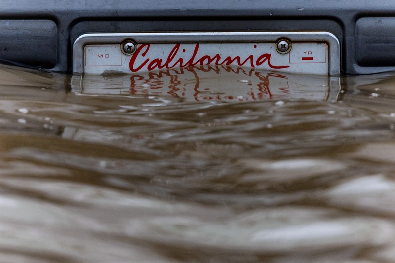 USA-WEATHER/CALIFORNIA A California plate is seen at an area affected by floods after days of heavy rain in Pajaro, California, U.S., March 14, 2023. REUTERS/Carlos Barria TPX IMAGES OF THE DAY