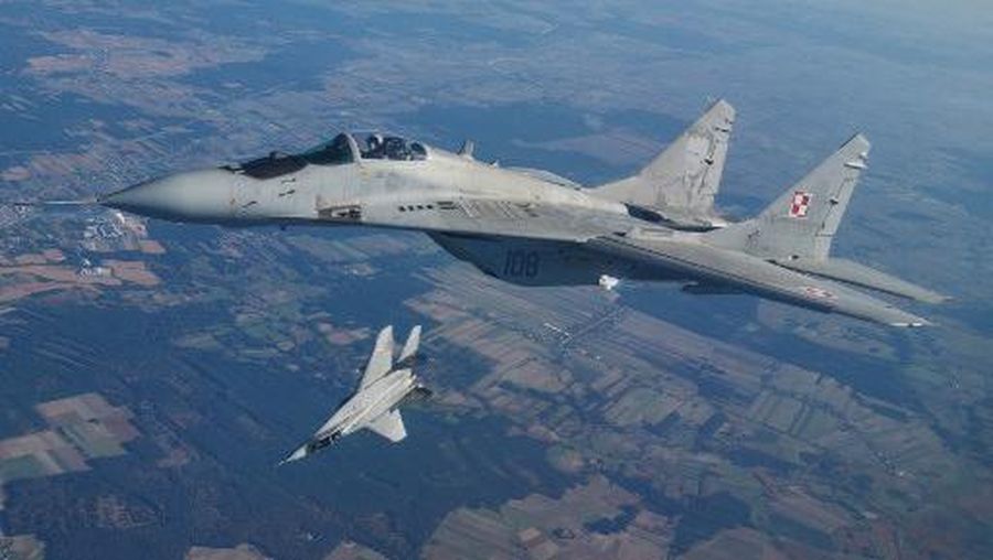 (FILES) This file photo taken on October 12, 2022 shows two MiG 29 fighter jets taking part in the NATO Air Shielding exercise near the air base in Lask, central Poland. - Polish President Andrzej Duda on March 16, 2023 said the EU member would deliver an initial batch of four Soviet-designed MiG-29 fighter jets to Ukraine soon. (Photo by RADOSLAW JOZWIAK / AFP)