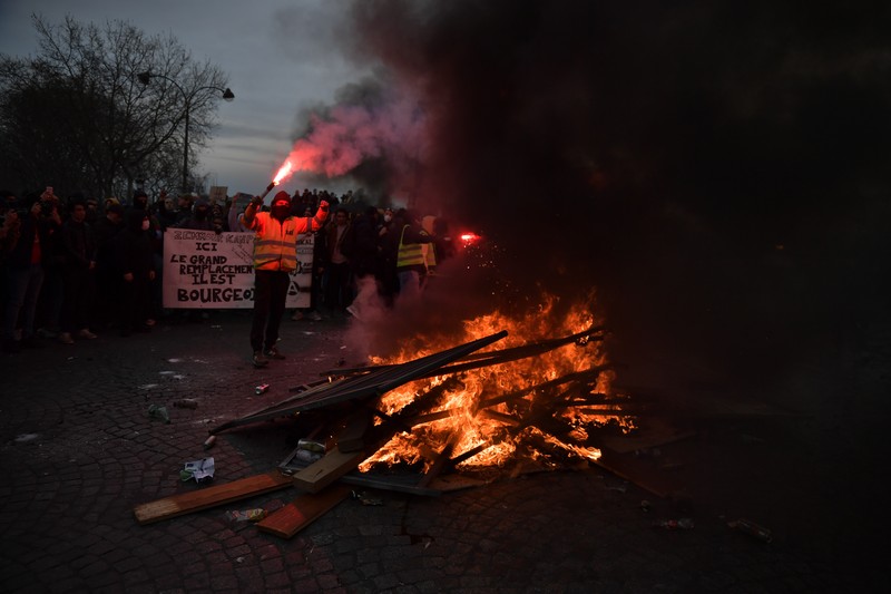 Para pengunjuk rasa membakar saat bentrokan terjadi dengan polisi anti huru hara selama demonstrasi menentang rencana pemerintah Prancis untuk menaikkan usia pensiun resmi di Paris, pada 16 Maret 2023. Para pengunjuk rasa membakar saat bentrokan terjadi dengan polisi anti huru hara selama demonstrasi menentang rencana pemerintah Prancis untuk menaikkan usia pensiun resmi di Paris, pada 16 Maret 2023. (Firas Abdullah/Anadolu Agency via Getty Images)