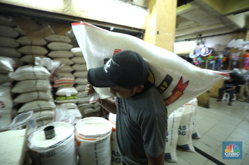 Penjual melayani pembeli beras di Pasar Ciledug, Tangerang Selatan, Jumat (17/3/2023). (CNBC Indonesia/Tri Susilo)