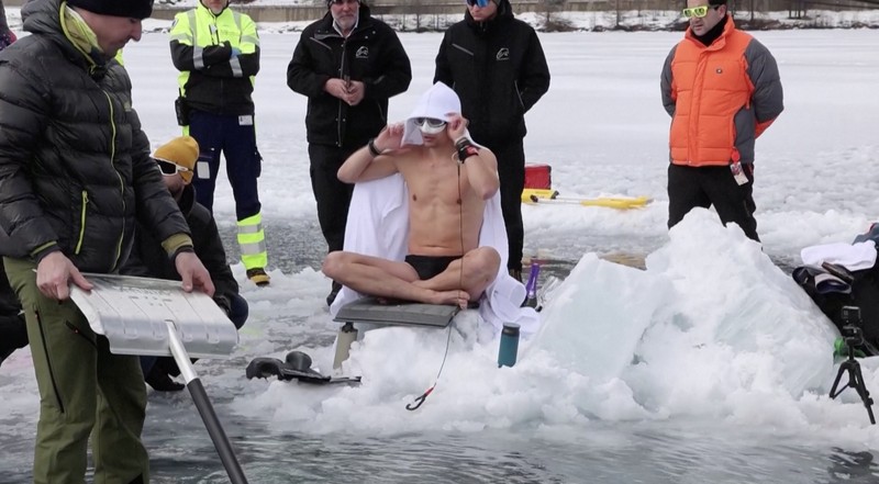 Czech freediver David Vencl dives to 52 metres under the ice of Lake Sils in one breath and wearing only a swimsuit in this picture taken from a video in Sils near St. Moritz, Switzerland March 14, 2023. David Vencl Organisation/Handout via REUTERS THIS IMAGE HAS BEEN SUPPLIED BY A THIRD PARTY. NO RESALES. NO ARCHIVES
