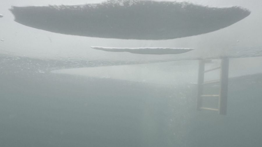 Czech freediver David Vencl dives to 52 metres under the ice of Lake Sils in one breath and wearing only a swimsuit in this picture taken from a video in Sils near St. Moritz, Switzerland March 14, 2023. David Vencl Organisation/Handout via REUTERS THIS IMAGE HAS BEEN SUPPLIED BY A THIRD PARTY. NO RESALES. NO ARCHIVES