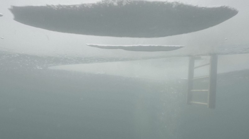 Czech freediver David Vencl dives to 52 metres under the ice of Lake Sils in one breath and wearing only a swimsuit in this picture taken from a video in Sils near St. Moritz, Switzerland March 14, 2023. David Vencl Organisation/Handout via REUTERS THIS IMAGE HAS BEEN SUPPLIED BY A THIRD PARTY. NO RESALES. NO ARCHIVES