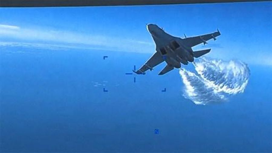 This handout image taken from video released by U.S. European Command (USEUCOM) on March 16, 2023, shows onboard footage from a U.S. Air Force MQ-9 drone as it is approached the first time by a Russian SU-27 aircraft jettissoning fuel, over The Black Sea on March 14, 2023. - Moscow said that it would try to retrieve the wreckage of a US military drone that crashed over the Black Sea in a confrontation Washington blamed on two Russian fighter jets. Russia also warned that it would react
