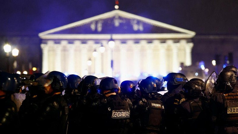 Api muncul ketika orang-orang menghadiri demonstrasi di Place de la Concorde untuk memprotes penggunaan pasal 49.3 oleh pemerintah Prancis, klausul khusus dalam Konstitusi Prancis, untuk mendorong RUU reformasi pensiun melalui Majelis Nasional tanpa pemungutan suara oleh anggota parlemen, di Paris , Prancis, 17 Maret 2023. (REUTERS/Gonzalo Fuentes)