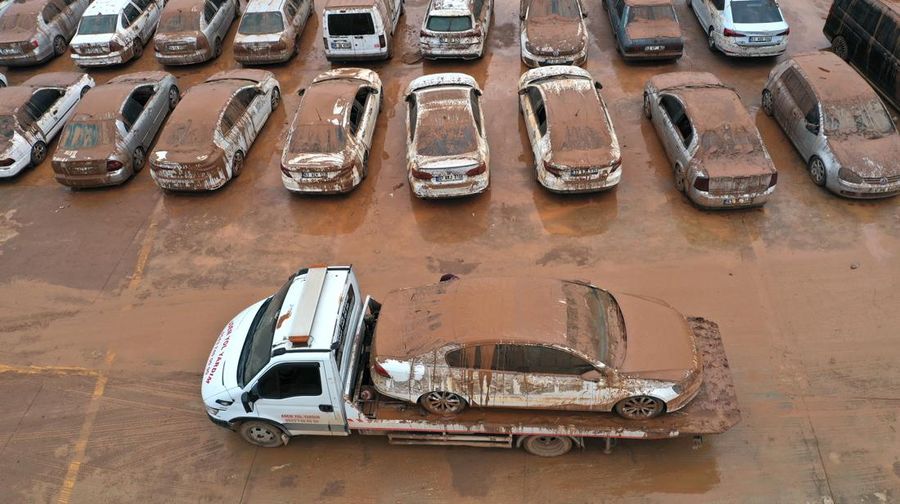 Kendaraan yang terjebak dalam lumpur di tempat parkir yang terendam banjir dekat Museum Arkeologi Sanliurfa dievakuasi, difoto, didokumentasikan, dan diparkir di tempat terbuka setelah hujan lebat menyebabkan banjir di Sanliurfa, Turkiye pada 18 Maret 2023. (Mehmet Akif Parlak/Anadolu Agency via Getty Images)