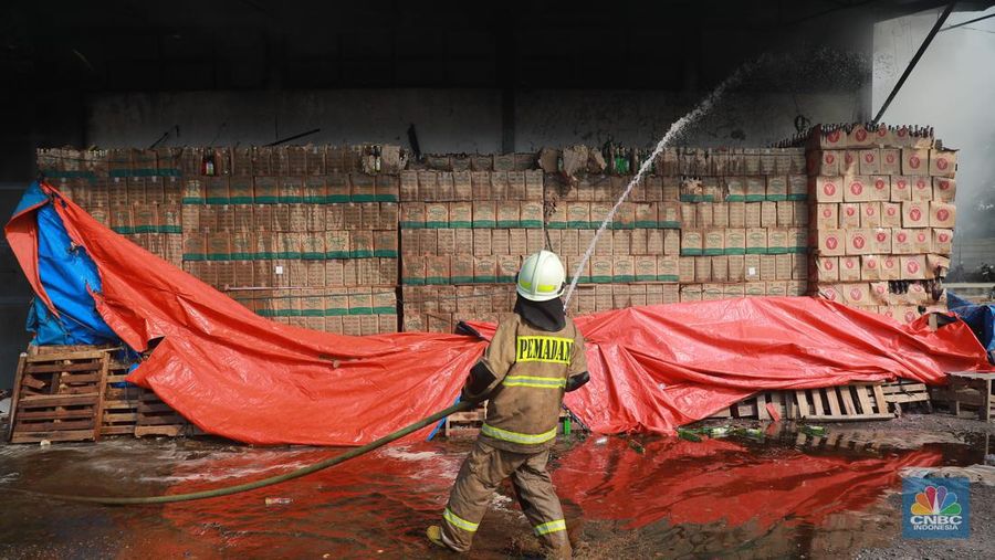 Petugas pemadam kebakaran memadamkan api saat kebakaran gudang sembako Indogrosir Cipinang di Kelurahan Pisangan Timur, Kecamatan Pulogadung, Jakarta Timur, Selasa (21/3/2023). (CNBC Indonesia/Muhammad Sabki)