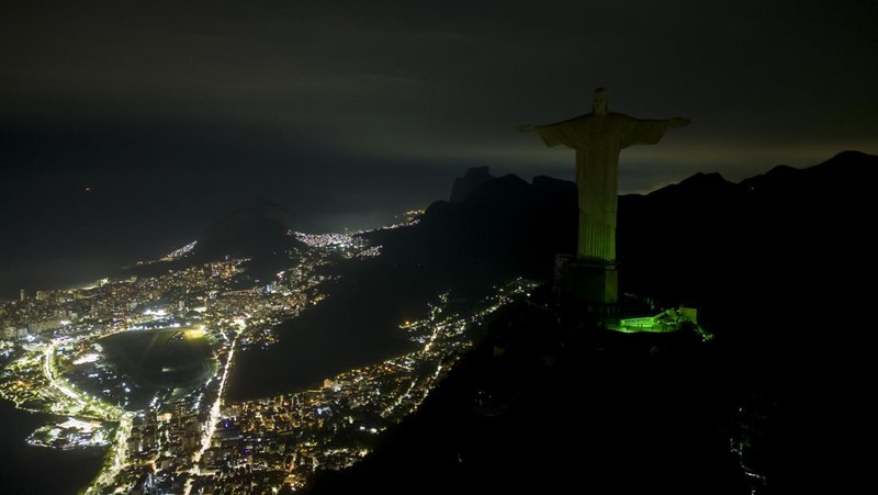 Patung Kristus Penebus terlihat setelah gelap gulita untuk Earth Hour pada (26/3/2023) di Rio de Janeiro, Brasil. (AFP via Getty Images/MAURO PIMENTEL)