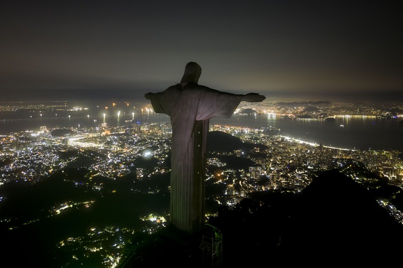 Patung Kristus Penebus terlihat setelah gelap gulita untuk Earth Hour pada (26/3/2023) di Rio de Janeiro, Brasil. (AFP via Getty Images/MAURO PIMENTEL)