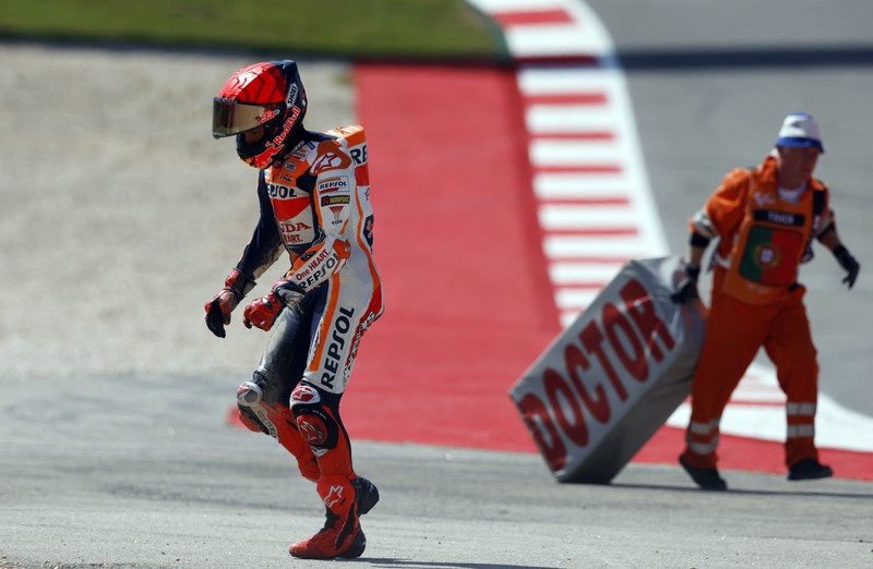 MotoGP - Portuguese Grand Prix - Algarve International Circuit, Portimao, Portugal - March 26, 2023 Repsol Honda Team's Marc Marquez and CryptoDATA RNF MotoGP Team's Miguel Oliveira after crashing during the race REUTERS/Marcelo Del Pozo     TPX IMAGES OF THE DAY
