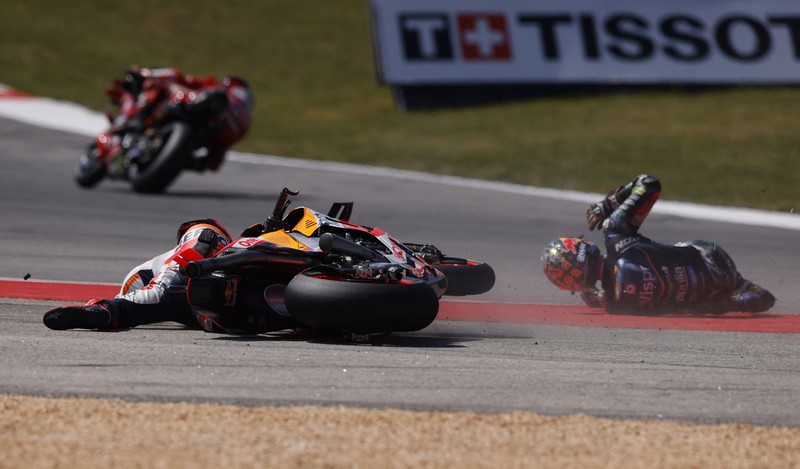 MotoGP - Portuguese Grand Prix - Algarve International Circuit, Portimao, Portugal - March 26, 2023 Repsol Honda Team's Marc Marquez and CryptoDATA RNF MotoGP Team's Miguel Oliveira after crashing during the race REUTERS/Marcelo Del Pozo     TPX IMAGES OF THE DAY