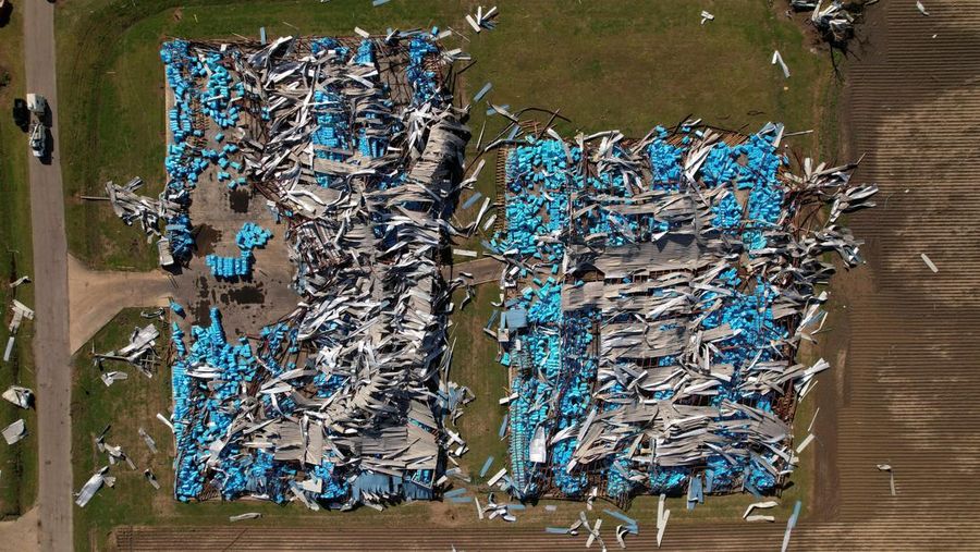 A vehicle is seen impaired by a piece of wood after thunderstorms spawning high straight-line winds and tornadoes ripped across the state, in Rolling Fork, Mississippi, U.S. March 26, 2023.  REUTERS/Cheney Orr