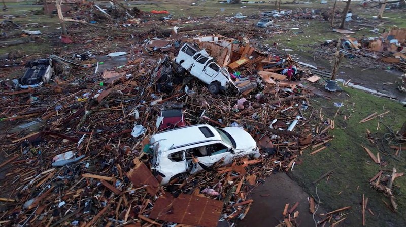 A vehicle is seen impaired by a piece of wood after thunderstorms spawning high straight-line winds and tornadoes ripped across the state, in Rolling Fork, Mississippi, U.S. March 26, 2023.  REUTERS/Cheney Orr