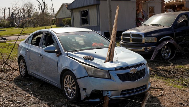 A vehicle is seen impaired by a piece of wood after thunderstorms spawning high straight-line winds and tornadoes ripped across the state, in Rolling Fork, Mississippi, U.S. March 26, 2023.  REUTERS/Cheney Orr