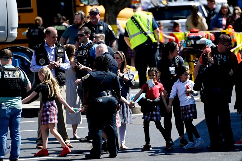 TENNESSEE-SHOOTING/ Children hold hands as they walk after a mass shooting at the Covenant School, in Nashville, Tennessee, U.S. March 27, 2023. TMX / Jozen Reodica/Handout via REUTERS THIS IMAGE HAS BEEN SUPPLIED BY A THIRD PARTY. NO RESALES. NO ARCHIVES. MANDATORY CREDIT