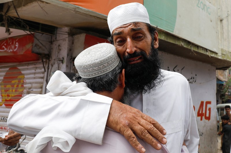 Umer Zada, father of seven year-old Saad Umer, who was killed with others in a stampede during handout distribution, mourns the death of his son during the funeral in Karachi, Pakistan April 1, 2023. REUTERS/Akhtar Soomro