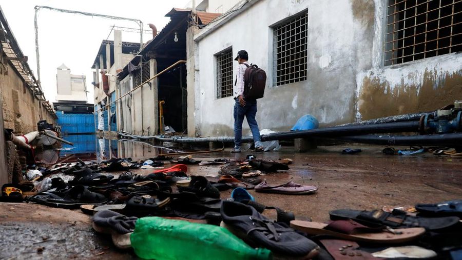 A view of a factory site with a pile of footwear after a stampede occurred during handout distribution, in Karachi, Pakistan March 31, 2023. REUTERS/Akhtar Soomro