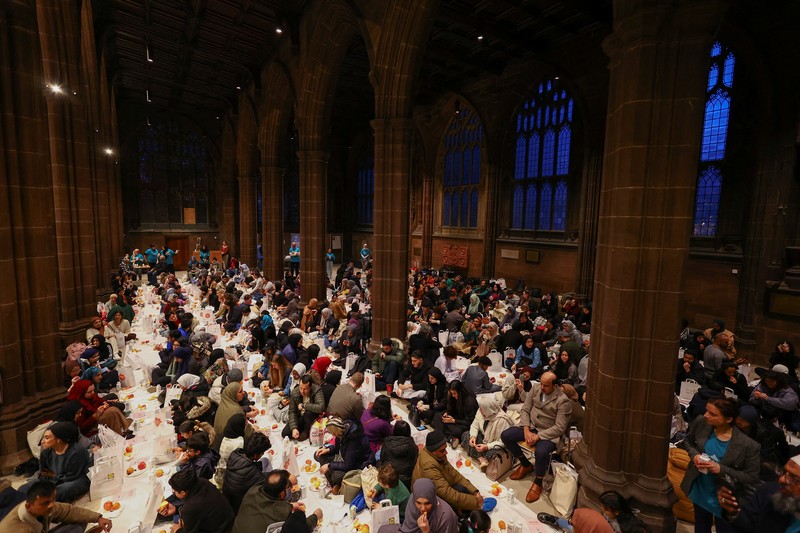 People queue outside Manchester Cathedral for the Iftar (breaking fast) event during the Muslim holy fasting month of Ramadan, in Manchester, Britain, March 29, 2023. REUTERS/Molly Darlington