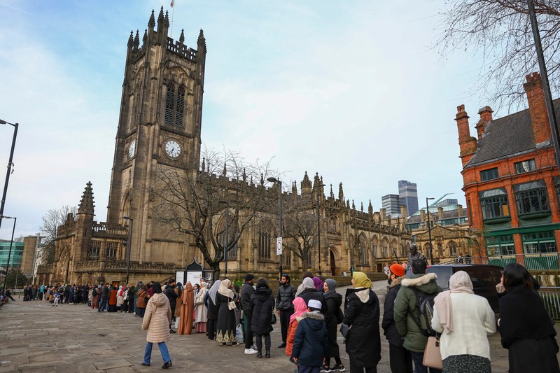 People queue outside Manchester Cathedral for the Iftar (breaking fast) event during the Muslim holy fasting month of Ramadan, in Manchester, Britain, March 29, 2023. REUTERS/Molly Darlington
